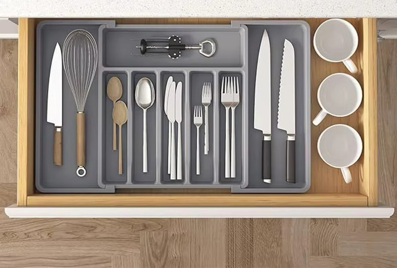 Grabbing cutlery from a PET drawer organizer box in the kitchen