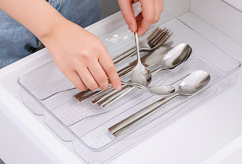 Grabbing cutlery from a PET drawer organizer box in the kitchen
