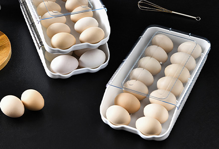 Stackable egg storage box with secure slots for fridge organization