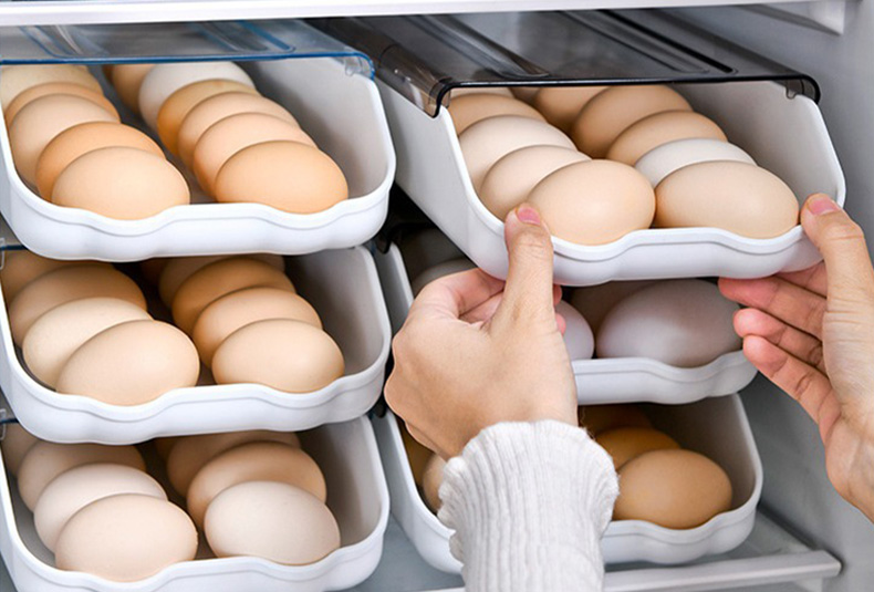 Stackable egg storage box with secure slots for fridge organization